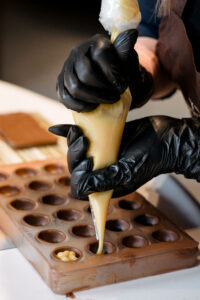 Piping white chocolate into tray